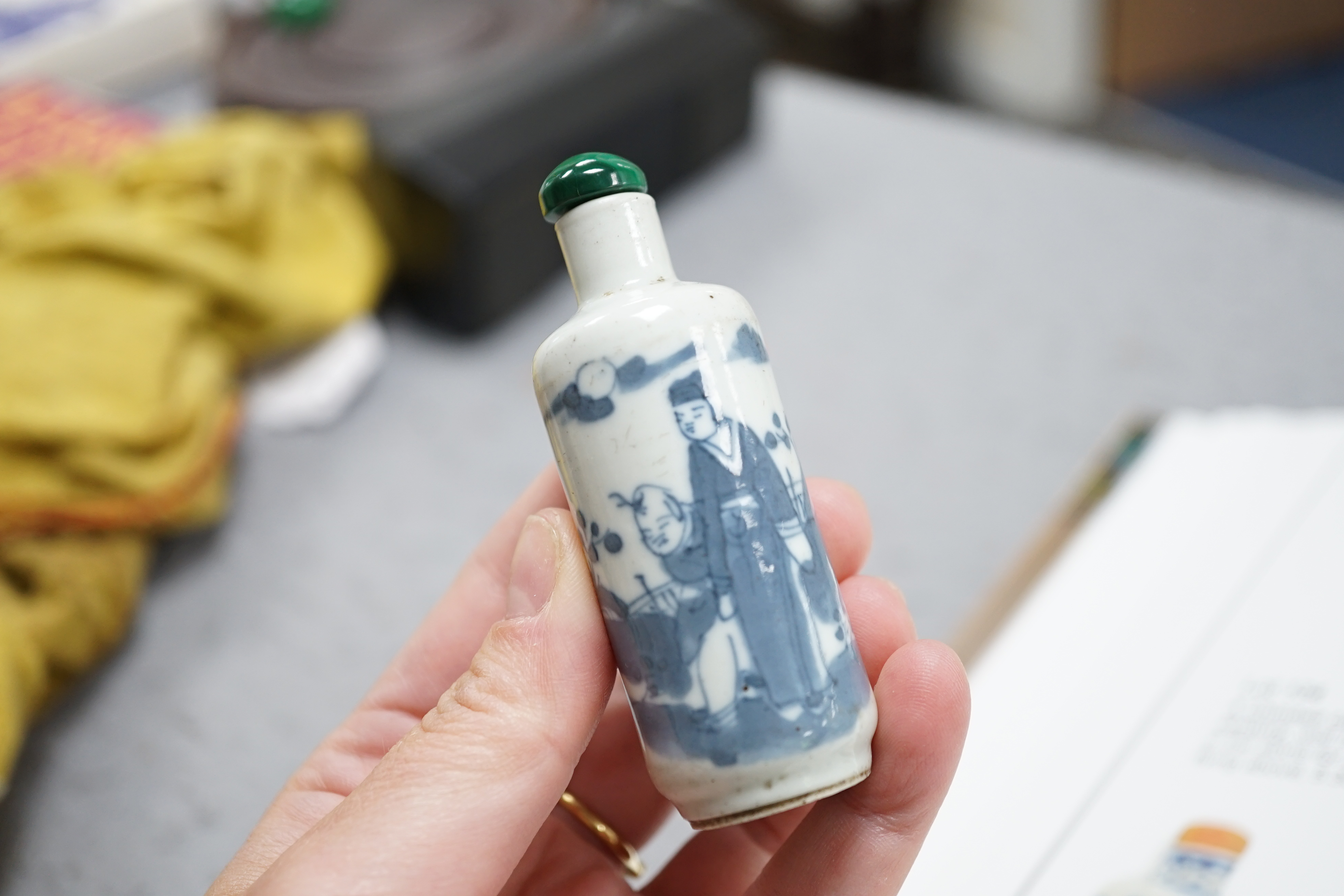 A Chinese iron red enamelled ‘dragon’ snuff bottle, Tongzhi mark and of the period (1862-74), together with two Chinese blue and white cylindrical snuff bottles, 19th century